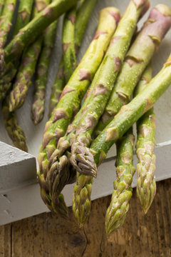 Bundle of fresh cut raw, uncooked green asparagus vegetable