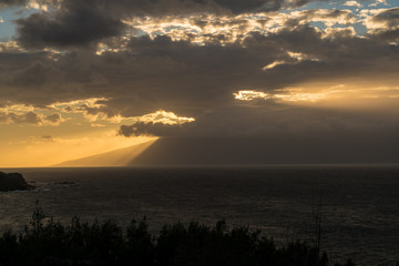Fototapeta na wymiar Sun setting behind the island of Molokai from Maui