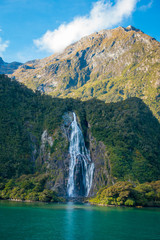 The view of a waterfall in Milford Sound, the most popular part of Fiordland National Park in New Zealand