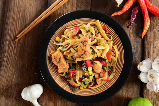 Traditional indonesian meal bami goreng with noodles, vegetables and chicken