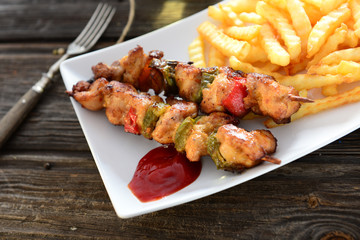 Skewers with fries and salad