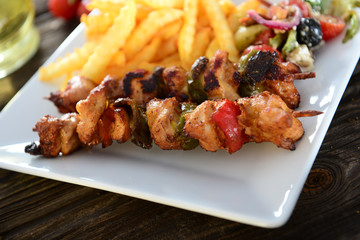 Skewers with fries and salad
