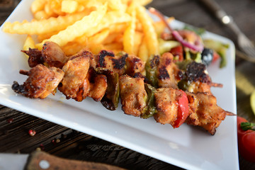 Skewers with fries and salad