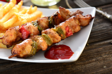 Skewers with fries and salad