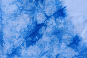 Pattern of blue dye on cotton cloth, Dyed indigo fabric background and textured