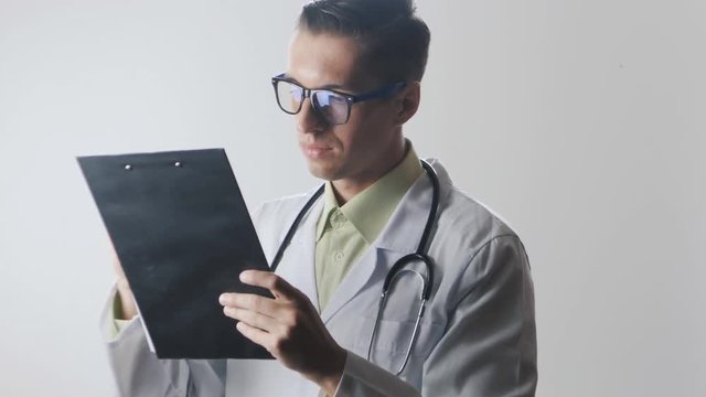 Doctor fills in the documents and invites them to sign.
