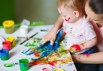 Mom and Daughter paint on canvas at the drawing school.