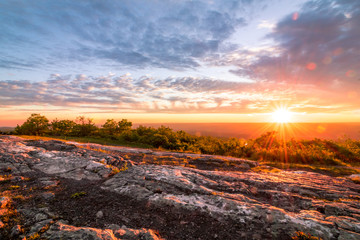 Sun sets over rocky granite at top of New Jersey, High Point State Park
