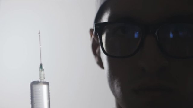 Close up Portrait of a doctor with a syringe. An injection