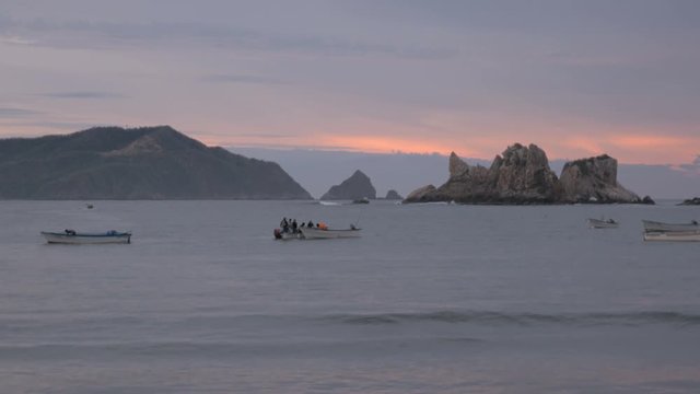 Men prepare their boats for their morning fishing on the ocean