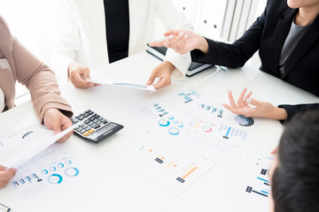 Business people discussing documents at meeting table