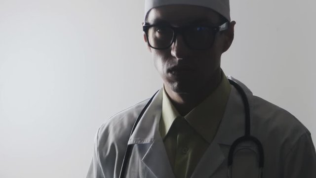 The doctor waves his index finger menacingly. Strict medical worker