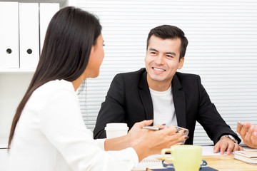 Businessman and  businesswoman discussing work in the meeting