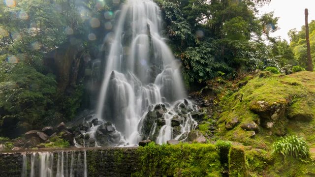 Scenic waterfall timelapse with water sprinkles in the Parque Natural Ribeira dos Caldeiroes in Sao Miguel, Azores, Portugal. 