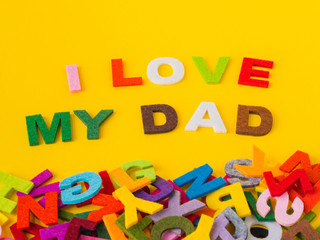 Father's day concept. I LOVE MY DAD alphabet on yellow background.