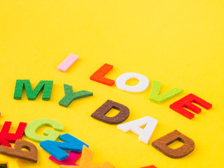 Father's day concept. I LOVE MY DAD alphabet on yellow background.