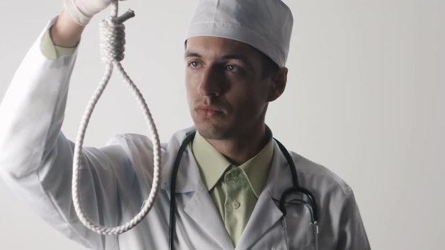 The doctor offers a choice between a noose and a medicine. The choice between suicide or treatment.