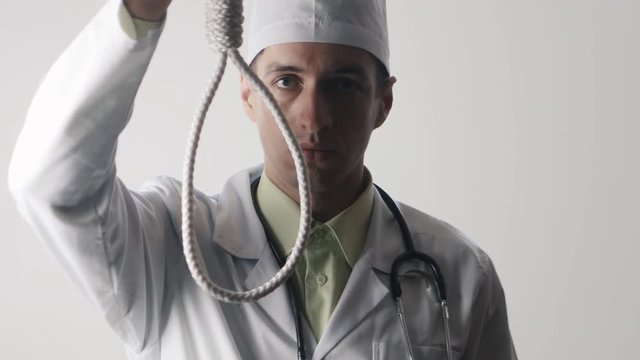 The doctor offers a choice between a noose and a medicine. The choice between suicide or treatment.
