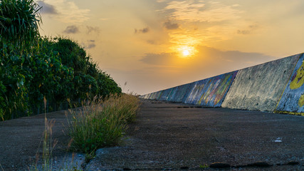 沖縄の堤防沿いからみる夕日
