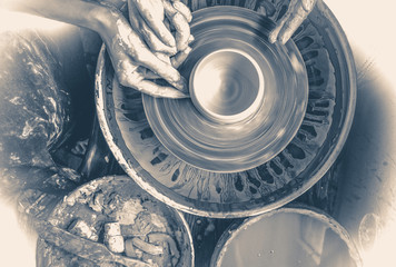 Old vintage photo. Master class on modeling of clay on a potter's wheel In the pottery workshop
