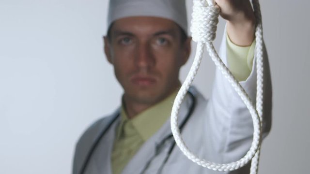 The doctor shows a noose. The medical worker advises suicide. The impotence of medicine. Doc makes a fatal diagnosis.