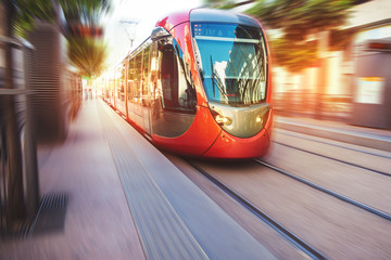 a fast moving tram in the streets of casablanca - obrazy, fototapety, plakaty