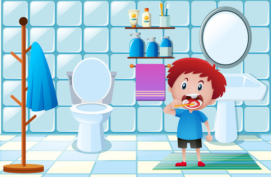 Little boy brushing teeth in toilet
