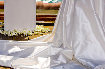 Fototapeta na wymiar Wedding gown train with flowers surrounding it