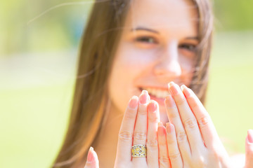 Portrait of young beautiful woman with long hair Shows beautiful nails on hands