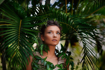 portrait of young beautiful woman at jungle background