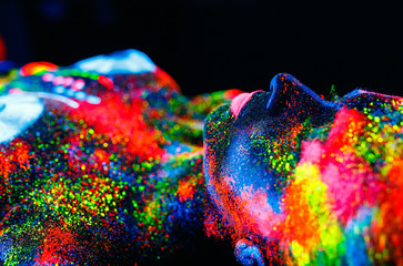 Concept. On the body of a girl painted DJ deck. Half-naked girl painted in UV colors.