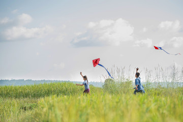 Asian children farmer flying a kite in the rice field.