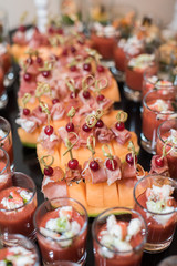 Cold seafood snacks in glasses and plates