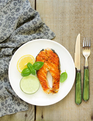 A piece of grilled salmon with tarragon sauce.