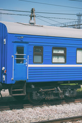 Blue passenger train wagon on the ways.