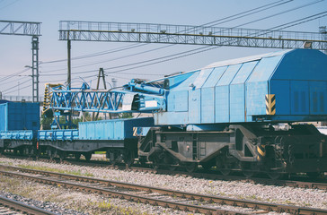 Fototapeta na wymiar Blue railroad crane on the ways.