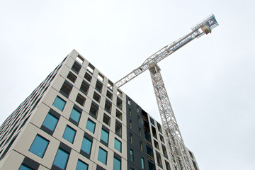 Fototapeta na wymiar Industrial construction crane in the city.