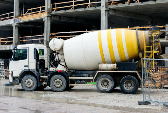 Concrete mixer truck on construction site.