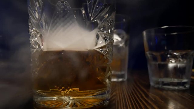 A Glass Of Whiskey Is On The Table. A Glass Of Alcohol, Video In The Bar.