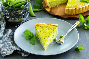 Homemade tart with green peas, bacon and cheese.