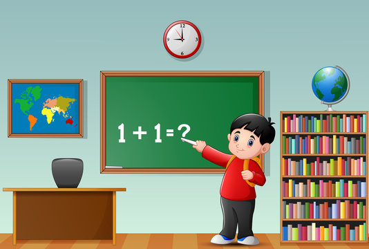 Cartoon school boy at blackboard in a classroom