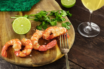 Cooked shrimps with a glass of white wine and copyspace