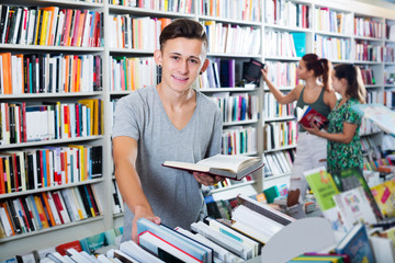 Boy holding book and looking