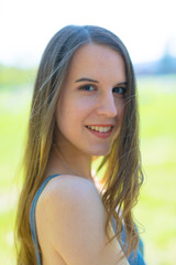 Head Outdoor Portrait of a brunette slim girl with long hair in the nature