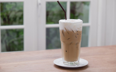 Iced coffee on the wood background. (vintage)