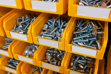 Sorted bolts in boxes in the store