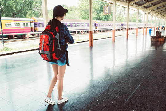 beautiful young asian girl traveling alone at train station, vintage tone 