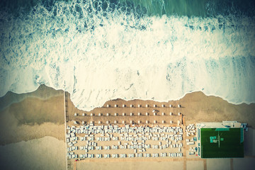 Top view of the sea and the beach with sun beds. Toned