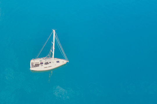 Top view of a white yacht in the blue sea