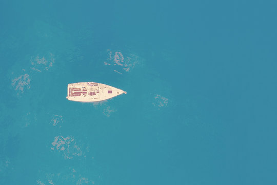 Top view of a white yacht in the blue sea